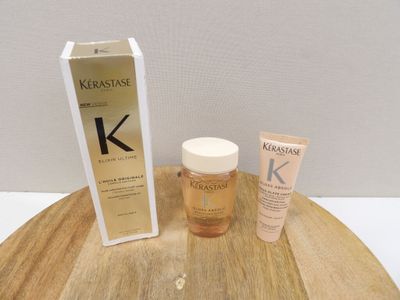 a bottle of kerastase and a tube of krastase on a wooden table