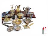 many different types of silverware on display on a table