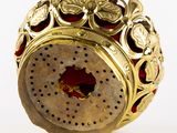 a gold and red object with a hole in it