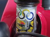 a close up of a red motorcycle with a sticker on it