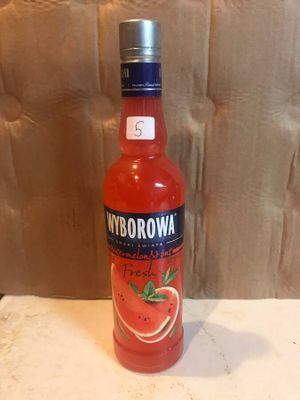 a bottle of watermelon sitting on a table