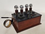 a small wooden box with five light bulbs on it
