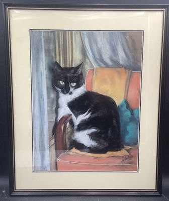 tableau représentant un chat noir et blanc assis sur une chaise rouge