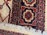 a cat sitting on a rug on a wooden floor