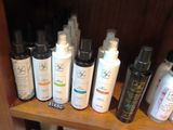 many different types of hair care products on a shelf
