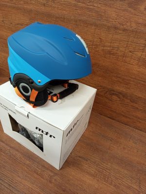 a blue helmet sitting on top of a box on a wooden floor