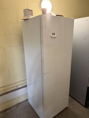 a refrigerator with a light on top of it in a room