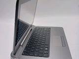 a silver laptop with a black keyboard on a white surface