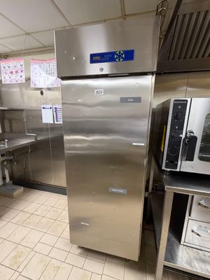 a large stainless steel refrigerator in a kitchen with a lot of counter space