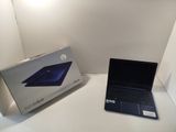 a laptop that is sitting on a table next to a box