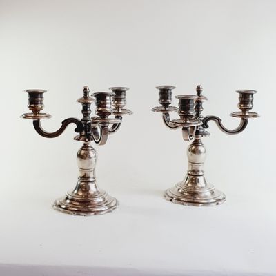 pair of silver plated candlesticks on a white background