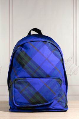 un sac à dos bleu posé sur une table en bois