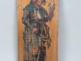 an old picture of a woman holding a stick in her hand