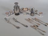 silverware and silverware sitting on a white table