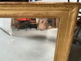 a mirror that is sitting on the floor in a room