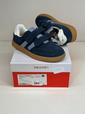blue and white shoes on a white box on a white surface