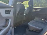 a car with the door open and a seat in the back