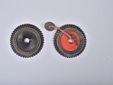 two buttons that are attached to each other on a white surface