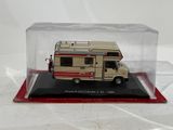a small model of a camper van in a clear case