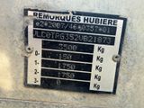 a sign on the side of a building that says remukques hubiere