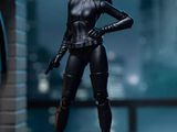 a close up of a person in a cat suit with a gun