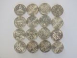 a lot of coins sitting on a white surface