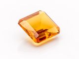 an orange topazte gems on a white surface