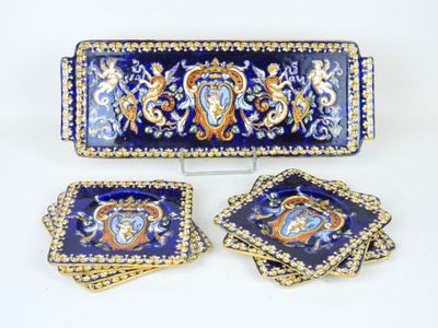 three pieces of blue and gold decorated dishes and a tray