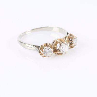 a close up of a ring with three diamonds on a white background
