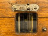 a close up of a wooden box with a latch on it