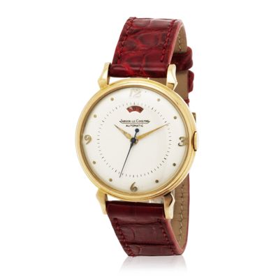 a close up of a wrist watch on a white surface