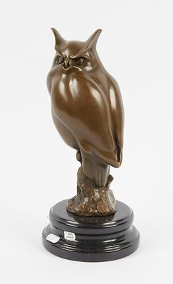 an image of a statue of an owl on a black base
