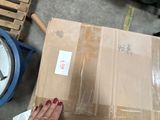 a person holding a pair of scissors near a box
