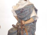 a figurine of a man riding a camel