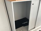 an image of a white cupboard in a room that is under construction
