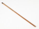 an old wooden stick with a wooden handle on a white surface