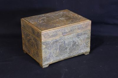 a small wooden box with a design on it