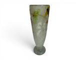 a glass vase that has a green and yellow design on it