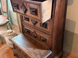 a dresser with a drawer on top of it in a room