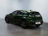 the rear end of a green car parked in a room
