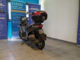 a scooter that is parked in front of a wall