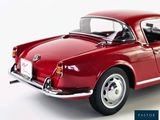 a red car that is sitting on a white surface
