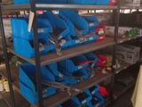 many blue bins on the shelves in the garage