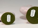 pair of green and white vases with labels on them