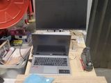 a laptop computer sitting on top of a wooden table