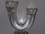a glass candle holder with smoke coming out of it