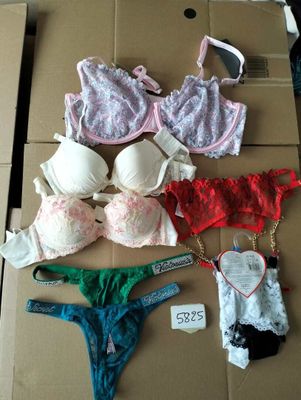 several bras and panties are on a cardboard box with a price tag