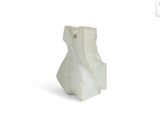 a white vase that is sitting on a white surface
