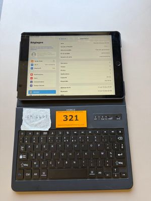 a tablet computer sitting on top of a laptop keyboard