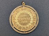 a gold medal with a medallion on it